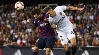 Lionel Messi of Barcelona wins a header against Valencia